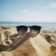 Sunglasses lying on sand